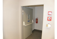 Požární dveře jednokřílé kovové s atypickým prosklením a instalovanou panikovou hrazdou